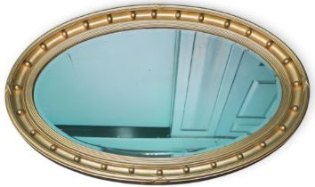 A 20th century oval gilt framed bevelled glass wall mirror, 64cm high x 99cm wide Condition Report: