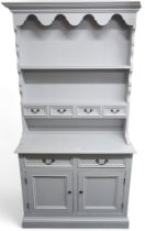 A contemporary powder blue painted kitchen dresser with four drawer plate rack over base unit with