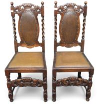 A pair of late 19th century oak hall chairs with brown Rexine upholstered back and seats
