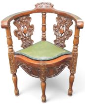 A 19th century walnut framed corner chair with pair of carved pierced splats over green