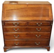 A 19th century mahogany writing bureau with fitted fall front writing compartment over two short and