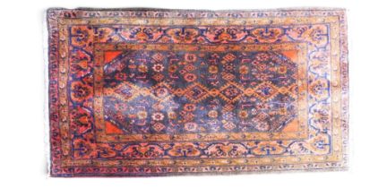 A blue ground Hamadan rug with multicoloured geometric patterned ground within pink geometric floral