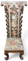 A 19th century rosewood framed Prie Dieu (prayer) chair with elaborate needle point upholstered back
