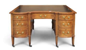 A Victorian walnut writing desk with shaped black skivered top over single long frieze drawer and