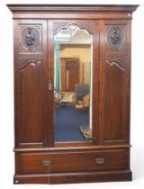 An early 20th century mahogany veneered wardrobe with moulded dentil cornice over central bevelled