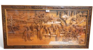 An early 20th century Chinese hardwood glazed wall carving depicting ladies at court on a riverfront