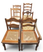 A lot comprising a pair of late 19th century oak framed single arm gossip chairs with carved