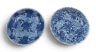 TWO CHINESE BLUE AND WHITE CHARGERS decorated with flowers on a diaper pattern ground, 18th/19th