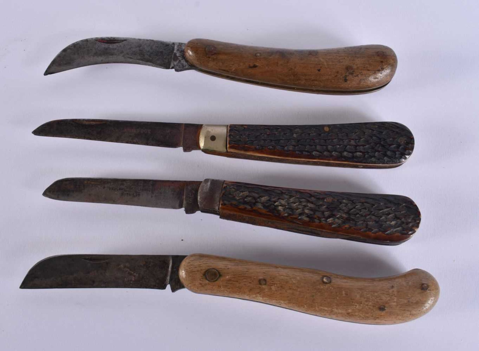 FOUR ANTIQUE HORN AND WOOD KNIVES. Largest 14cm long extended. (4) WE ARE UNABLE TO OFFER IN HOUSE