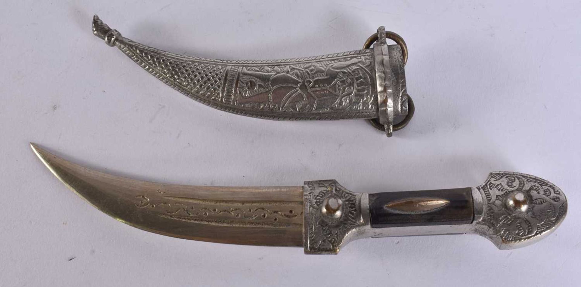 A MIDDLE EASTERN WHITE METAL OVERLAID DAGGER. 20.5 cm long. We are unable to offer in-house shipping
