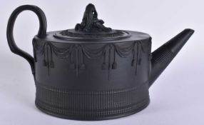 A MID 19TH CENTURY ENGLISH BLACK BASALT TEAPOT AND COVER overlaid with swags. 23 cm wide.