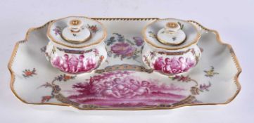 A 19TH CENTURY AUSTRIAN VIENNA PORCELAIN DESK STAND painted with putti in puce. 26 cm x 18 cm.