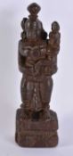 AN EARLY INDIAN CARVED WOOD DEITY modelled with an attendant. 27 cm high.