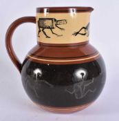 AN UNUSUAL BROWNFIELD POTTERY JUG decorated with fantastical figures. 16 cm x 14 cm.