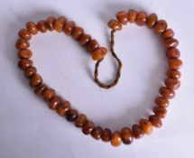 A TRIBAL AMBER NECKLACE. 159 grams. 76 cm long.