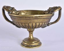 AN UNUSUAL 17TH/18TH CENTURY BRONZE TWIN HANDLED MASK HEAD CUP. 11.5 cm wide.