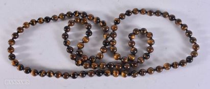 A TIGER'S EYE STRING BEAD NECKLACE. 86 grams. 96 cm.