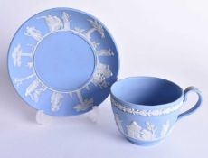 Mid 19th century Wedgwood blue jasperware cup and saucer with applied neo-classical designs,