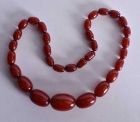 Cherry Bakelite Graduated Necklace. 44 cm long, largest bead 2.5 cm wide.