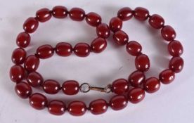 A BEADED BAKELITE NECKLACE. Untested. 184 grams. 84 cm long, each bead 2 cm wide.