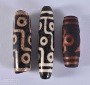 THREE AGATE DZI BEADS. 5.8 x 1.3 cm.