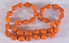 A ORANGE BEAD NECKLACE. 56 grams. 64 cm.