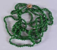 A 14CT CLASP STRING JADE BEAD NECKLACE. 317 grams. 61 cm.