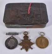 A MILITARY CHRISTMAS TIN together with three medals presented to 2666 Pte T Jacklin Ling R. (4)