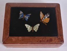 A 19TH CENTURY ITALIAN GRAND TOUR PIETRA DURA BUTTERFLY PANEL inset within a later leather box. 13