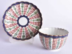 18th century Worcester teabowl and saucer painted with the Hop Trellis pattern having over-glaze
