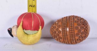 A Carved Coquilla nut Thimble holder together with a Pin Cushion 6 cm (2)