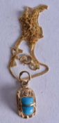 A 14CT GOLD AND TURQUOISE NECKLACE. 2.4 grams. 45cm long, pendant 1.5 cm x 1 cm.