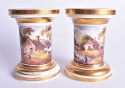 Early 19th century English porcelain fine pair of candlesticks each painted with a continuous