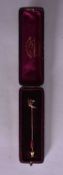A 15 Carat Ruby, Diamond & Sapphire Stick Pin in a fitted case. Stamped 15CT, 6.5 cm x 0.8 cm,