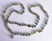 A Green Jade Bead Necklace with Silver Gilt Mounts and Spacer Beads. Stamped Silver. 78cm long,