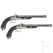 Ein hochwertiges Paar ebenholzgeschäfteter Perkussionspistolen im Kasten, Paris, um 1840/50
