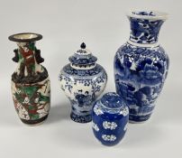 AN ORIENTAL BLUE AND WHITE LIDDED URN MARKED 