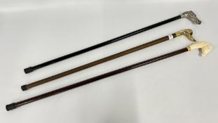 THREE WALKING STICKS WITH NOVELTY HANDLES FEATURING HORSES AND A DUCK.