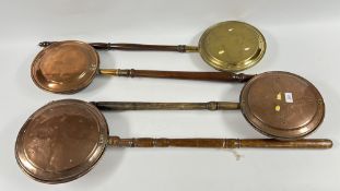 FOUR REPRODUCTION BRASS / COPPER BED WARMING PANS.