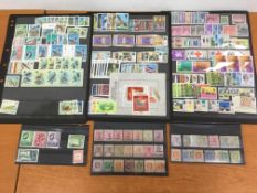 STAMPS: SEYCHELLES 1954-2004 COLLECTION ON PRINTED LEAVES PLUS A FEW OLDER ISSUES ON STOCKCARDS.