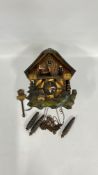 A GERMAN CUCKOO CLOCK AND WEIGHTS.