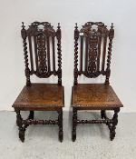 A PAIR OF ANTIQUE VICTORIAN GOTHIC REVIVAL OAK HALL CHAIRS ON BARLEY TWIST SUPPORTS.