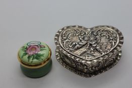 A SILVER HEART SHAPED TRINKET BOX EMBOSSED WITH CHERUB DESIGN,