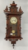 A MAHOGANY FINISH VIENNA STYLE WALL CLOCK.