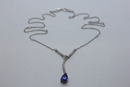 AN 18CT WHITE GOLD DIAMOND AND TANZANITE NECKLACE THE PEAR SHAPE TANZANITE CLAW SET IN A DIAMOND