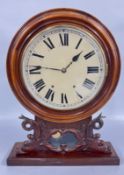 AN ANTIQUE MAHOGANY SHELF CLOCK WITH CARVED SCROLL DOLPHIN SUPPORTS (KEY AND PENDULUM).