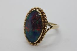 AN OVAL OPAL TRIPLET RING,