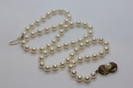 A SINGLE STRAND OF LOTUS SIMULATED PEARLS WITH GOLD PLATED SILVER FITTINGS IN ORIGINAL BOX.
