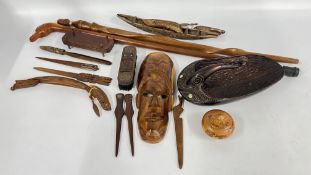 A BOX OF ETHNIC CARVED ARTIFACTS TO INCLUDE A WALKING CANE & A WALL MASK + A FURTHER CARVED DUCK