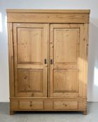 A VINTAGE WAXED PINE TWO DOOR, TWO DRAWER WARDROBE.